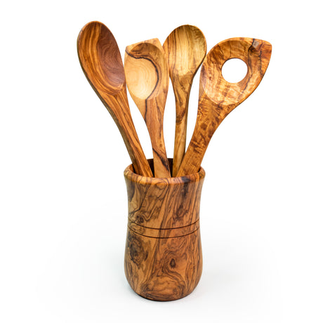 A set of olive wood kitchen utensils including a spoon, cooking spoon, spatula, and risotto spoon, displayed in a matching round holder.